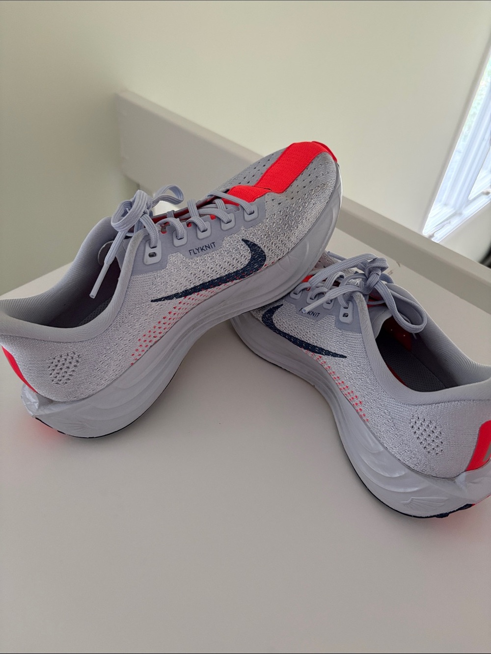 Nike women’s Gray and Red Flyknit Running Sneakers